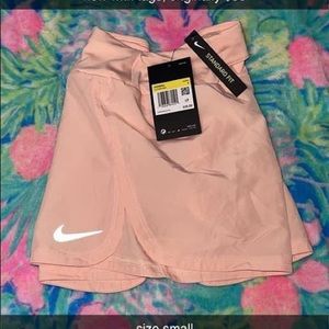 Light pink Nike shorts.